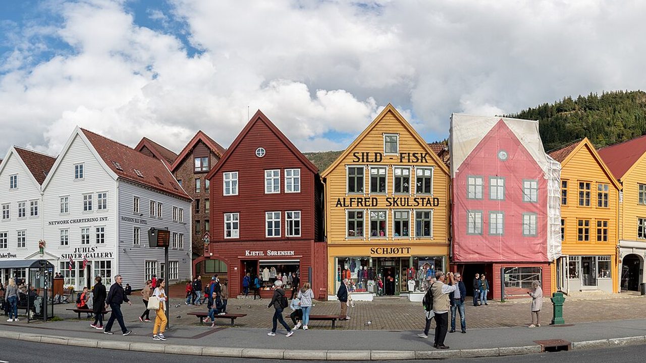 The coloured wooden buildings of Bryggen on the Bergen waterfront on a bright day with white clouds